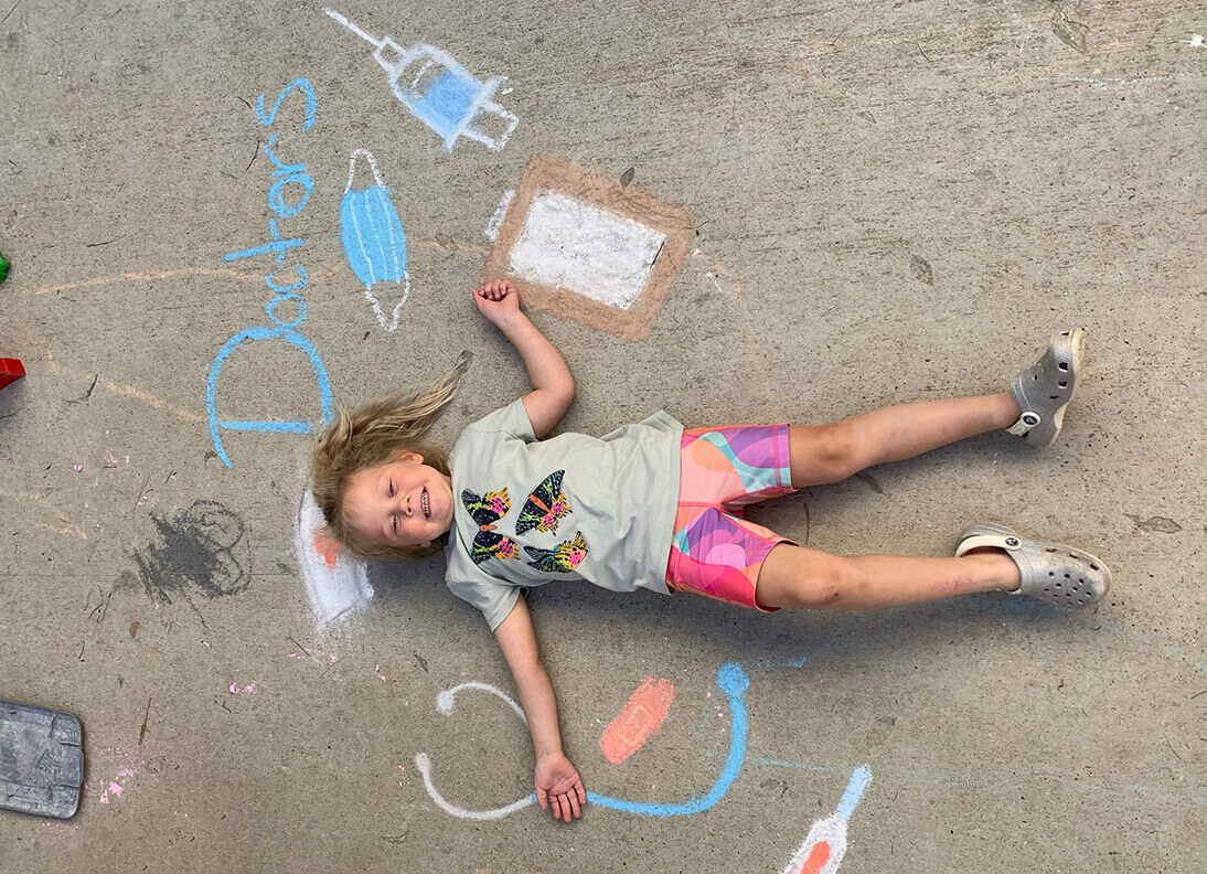 Kid playing outside with chalk