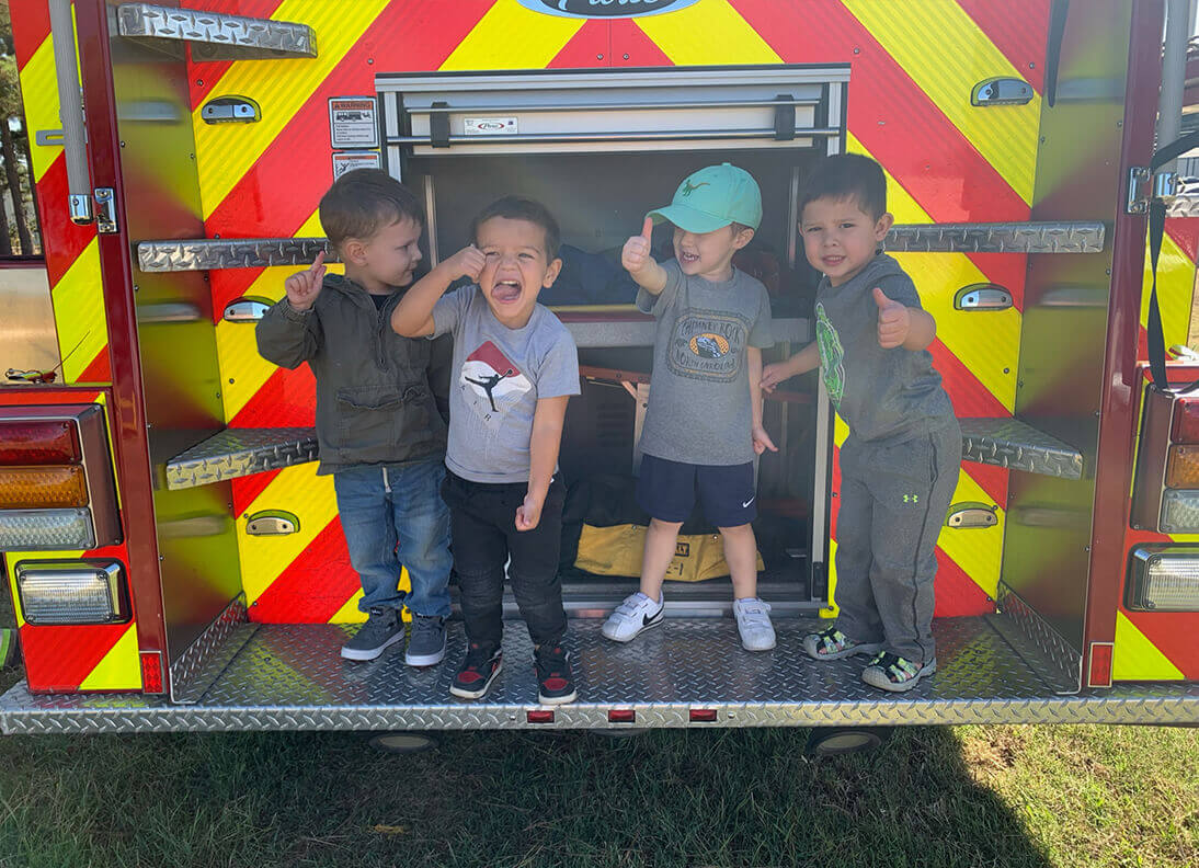 Bloom kids playing on a fire truck